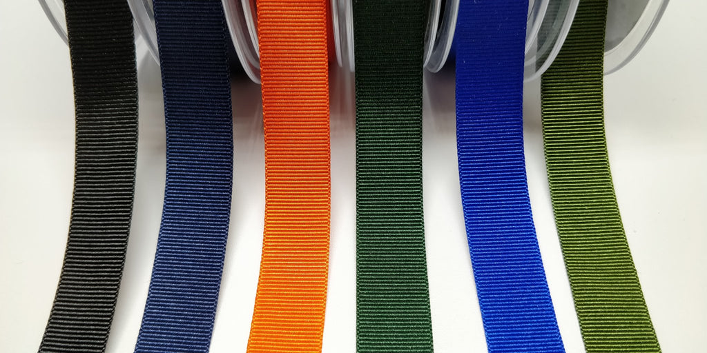 Grosgrain 16 millimetre ribbon tape shown in black, navy, orange, forest green, royal and olive