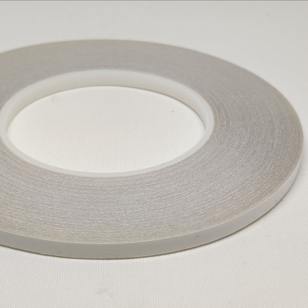 Roll of 9 millimetre wide clear double sided seaming tape
