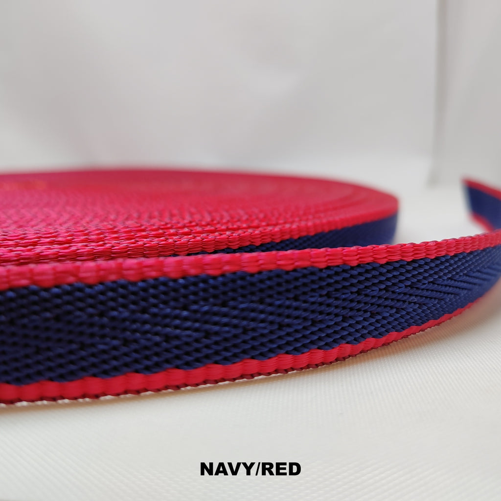 Roll of red herringbone webbing with a single thick navy blue stripe through the centre