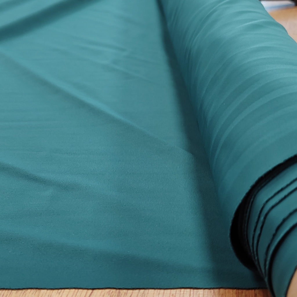 Roll of forest green lycra fabric