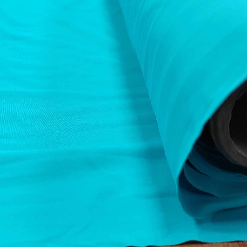 Roll of turquoise lycra fabric