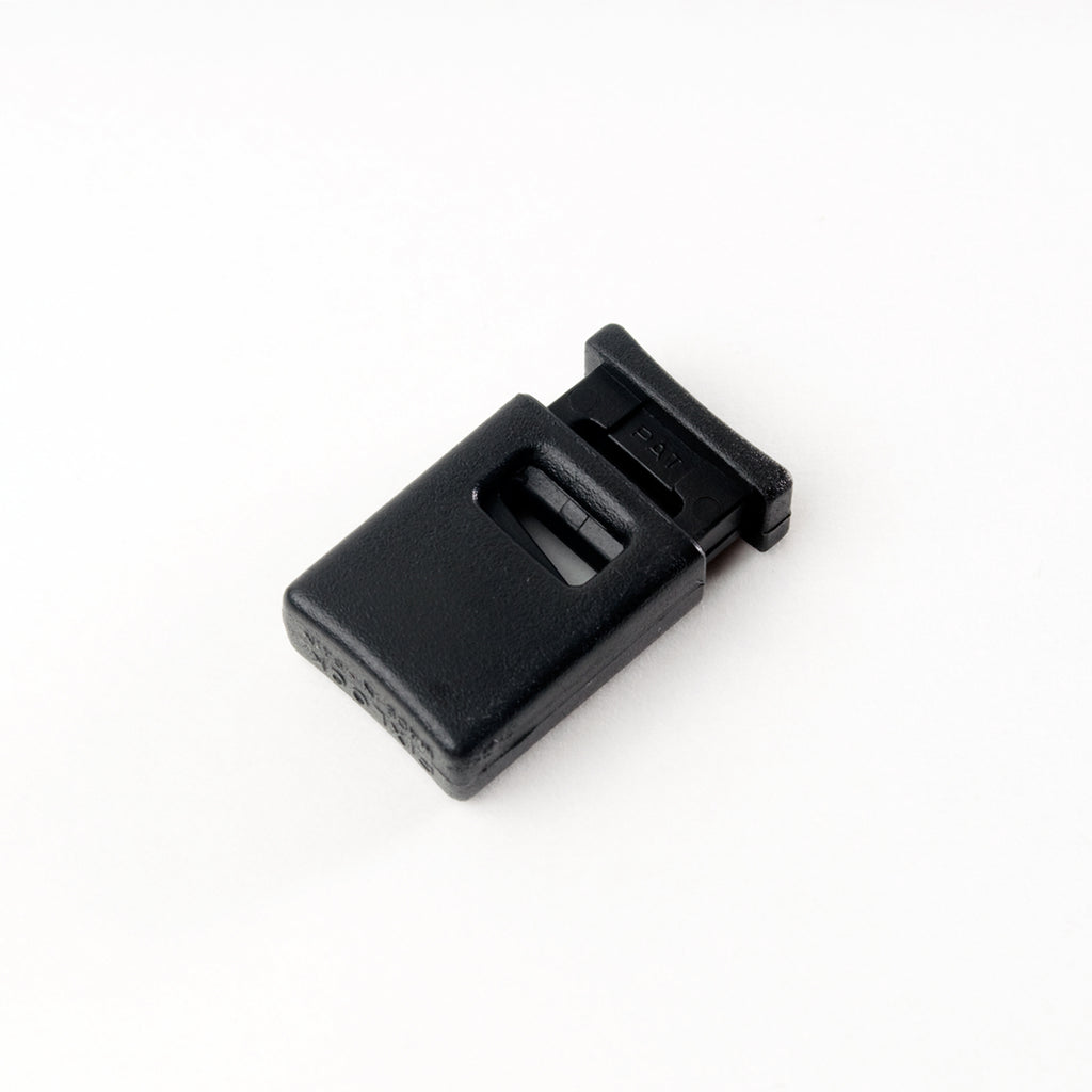 Black plastic rectangular cord lock on a white background
