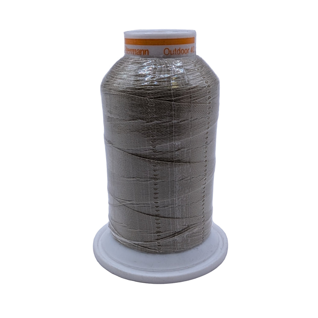 Spool of beige outdoor 40 thread on a white background