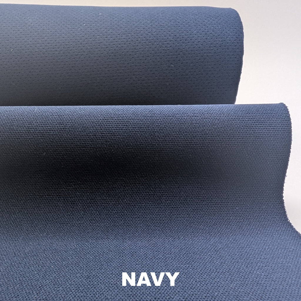Roll of Navy softshell fabric on white background