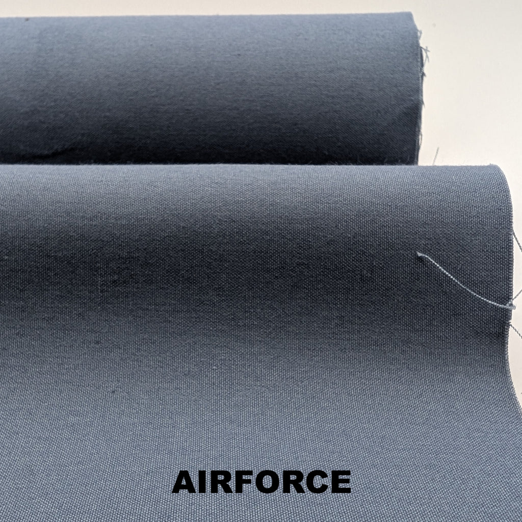 Roll of airforce blue breathable cotton fabric on white background