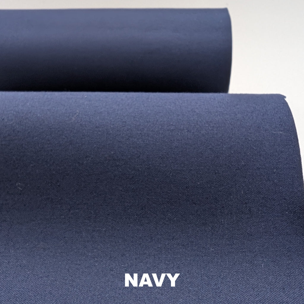 Roll of navy breathable cotton fabric on white background