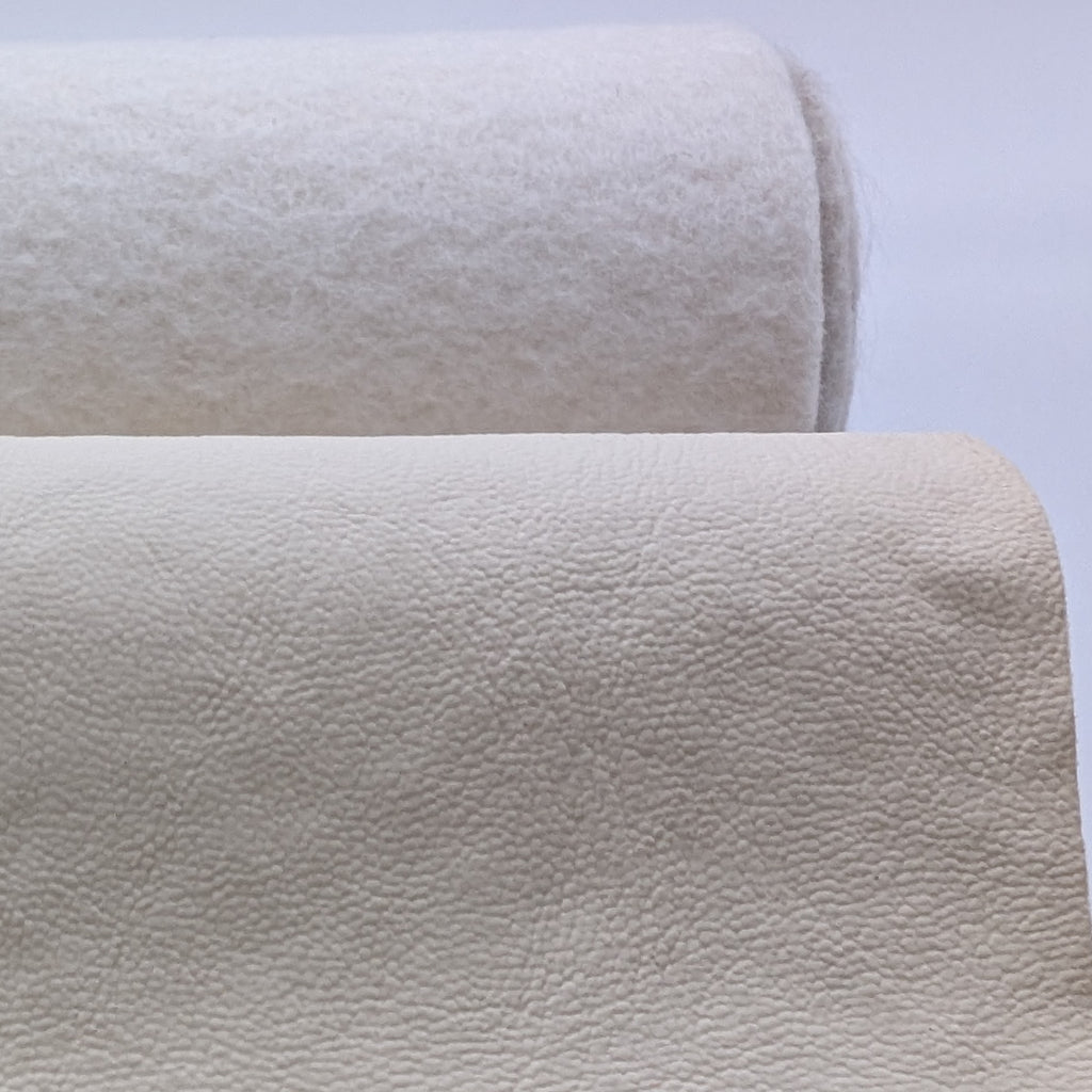 Roll of off-white fabric with fluffy white backing