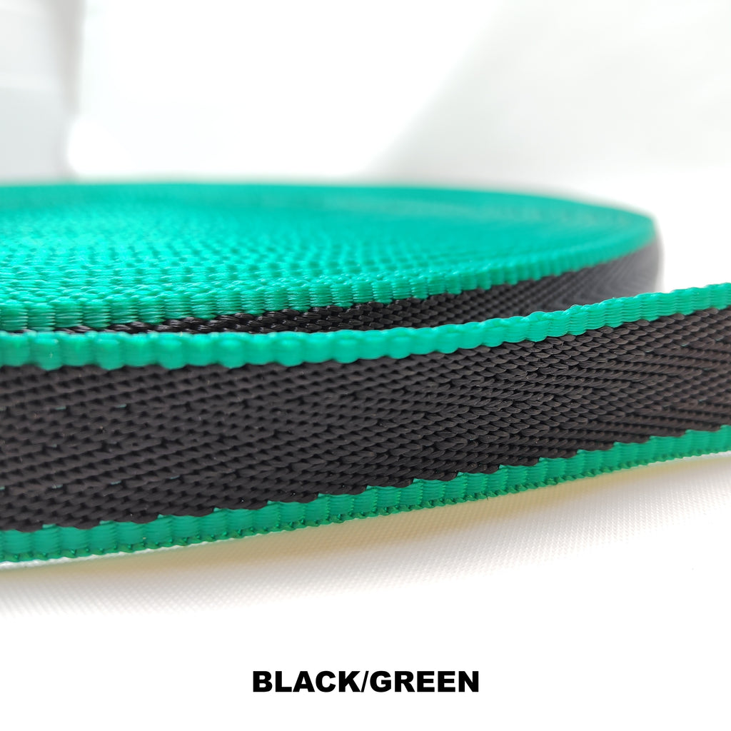 Roll of green 25 millimetre herringbone webbing with single thick black stripe running through the centre