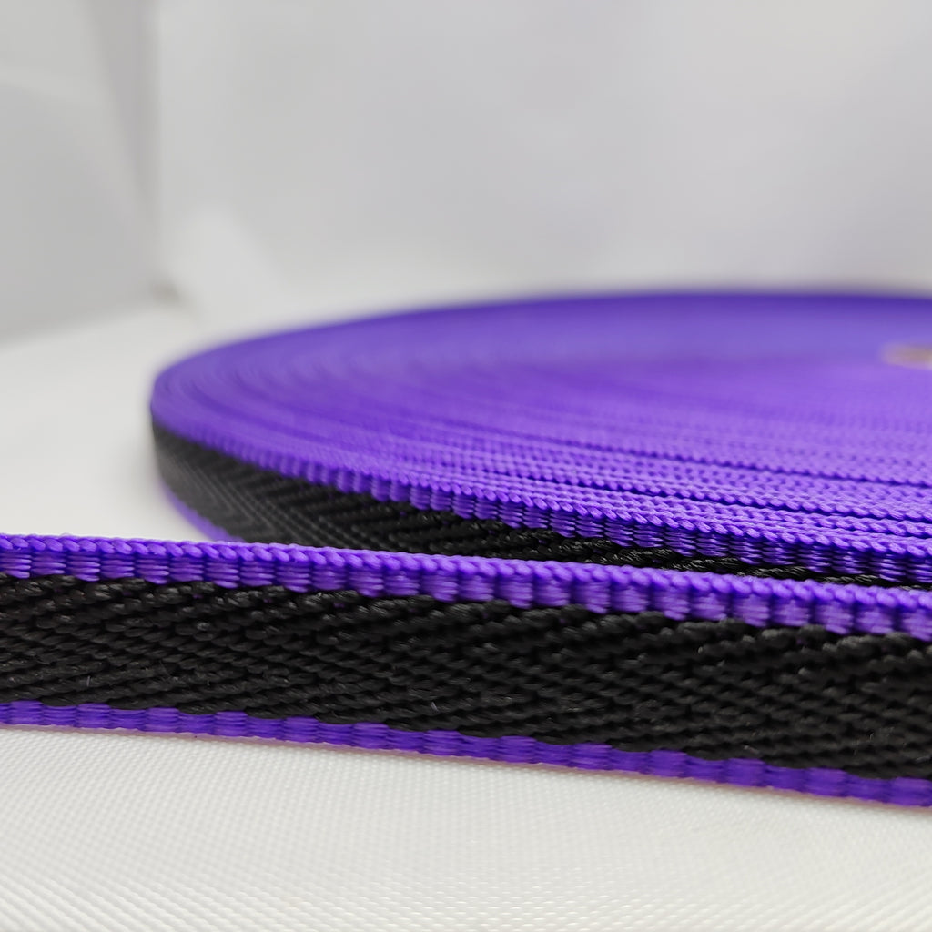 50 metre roll of purple herringbone webbing with thick black stripe running through the centre